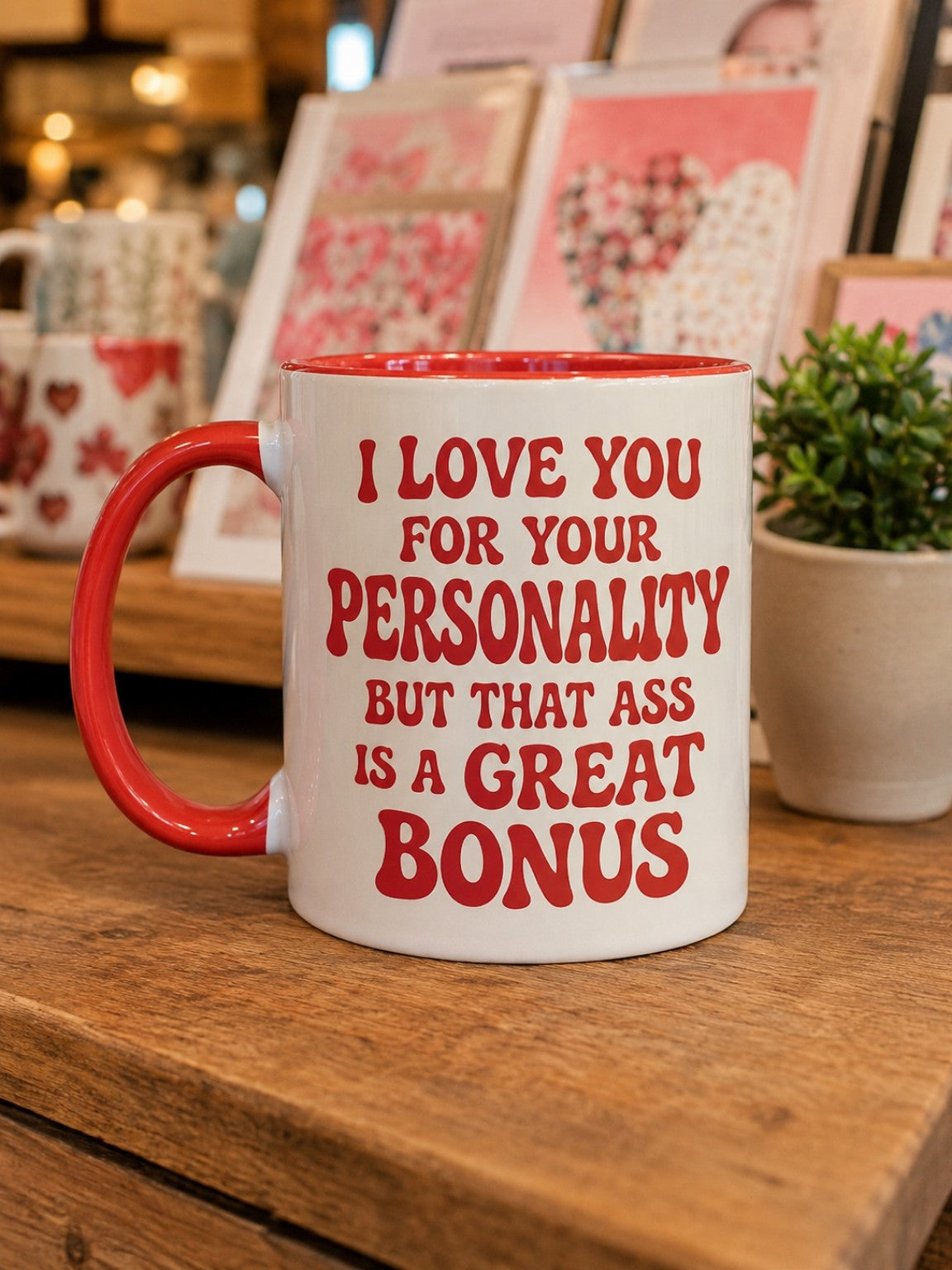 White mug with red handle and red lettering reading I love you for your personality but that ass is a great bonus